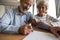 Close up satisfied older couple signing documents, making deal