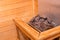 Close up of sauna stow covered with stones on which water is thrown in order to produce steam.Heater with hot stones in