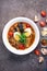 Close-up Savory Ramen Bowl with Colorful Fresh Ingredients on Dark Background