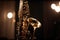 Close-up of a saxophone with reflections and a soft bokeh of light in the background created with generative AI technology