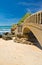 Close up of scenic stone footbridge on sandy beach in scenic seascape of atlantic coast in blue sky in vertical position, biarritz