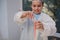 Close-up schoolboy's hands hold test tubes with solution coming out, chemical reaction occurs during a chemistry