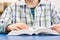 Close Up Of Schoolboy Studying Textbook