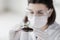 Close up of scientist with plant and soil in lab