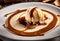 A close-up of a scoop of caramel swirl ice cream with caramel sauce on top.