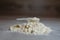 Close-up scoop in protein powder slides on a wooden table.