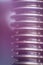 Close-up of a screw bolt in lilac and purple on a dark background. Bright stylish wallpaper for the design of an auto parts store
