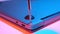 Close-up of screwing bolt into laptop cover in red blue light