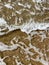 Close-up of the sea coast, clear sea water with shallow waves and a narrow strip of white foam with bubbles washes the