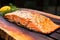 close-up of seasoned salmon fillet on a cedar plank