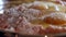 Close-up of seasoning with salt and black pepper the stuffed meat in the metallic bowl. The process of cooking cutlets.