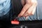 Close-up of seat belt mounting of a young man in a car, a female driver fastens a seat belt