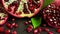 Close-up segments with fresh pomegranate arils on black background