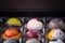 Close up of selection of colorful sweet delicious round shape chocolates in a box