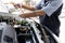 Close up and Selective focus of car mechanic holding battery electricity cables jumper for charging car battery, Services car