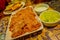 Close up of selective focus of delicious typical chilean food served in a white plates and bowls over the table of a