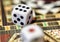 Close up with selective focus of dice on a colorful game board for a game of chance