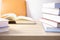 Close up and selective focus photo of science textbook opening page and stacks of many books as foreground and beautiful sunlight