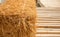 Close up and selective focus shot with copy space of straw stack packed on dried bamboo floor which is decorated in rural farming