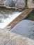 Close up, selective focus of water texture in small stone waterfall. Many air bubbles, cascade. Natural background or