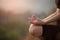 Close up with selective focus of yogi fit young woman practicing yoga exercises, breathing, meditating, Lotus pose