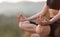 Close up with selective focus of yogi fit young woman practicing yoga exercises, breathing, meditating, Lotus pose