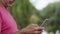 Close up of senior bearded man looking at mobile screen