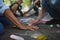 Close-up of senior couple with grandchildren drawing with chalks on pavement outdoors in park.