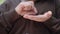 Close-up of senior female hands counting coins. Unrecognizable Caucasian old woman calculating cents in palms. Poor