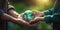 close-up of senior hands gifting a small planet Earth to a child against a defocused green background, creating a touching moment