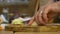 Close-up of senior house wife hands cutting an onion preparing dinner for family