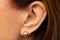 Close up of senior woman ear with golden earring