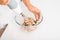 Close-up of senior woman\'s hand preparing cream pie filling, housewife whipping ingredients using blender mixer indoors