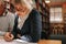 Close up of a senior woman writing in her book