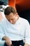 Close-up of a serious-faced chef working in a professional restaurant kitchen