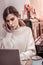 Close up of serious handworking woman working in cute cafe