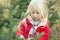 Close-up of serious little girl walking in forest