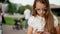 Close up serious teenage girl browsing smartphone in summer park