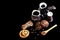 Close-up set of coffee dishes, espresso coffee, milk and cocoa spoon, round crunchy chocolate cookies with coffee beans, sticks of