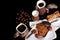 Close-up set of coffee dishes, espresso coffee, milk, round crunchy chocolate cookies with coffee beans, sticks of cinnamon, anise