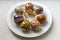 Close up of seven easter eggs on a white plate. Traditional Ukrainian patterns.