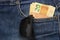 Close up of several 20 reais bills in the pants pocket. Sunglasses hanging in the pocket. Money in pocket concept. Money-rich