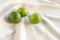 Close-up on several limes on white table tablecloth.  Food photography using natural window light. Juicy, seedless Lime has strong