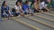 Close up of several vietnamese youth moving bamboo poles for a tinikling game near hoan kiem lake in hanoi