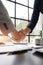 Close up shake hands, Considering buying a home, investing in real estate. Broker signs a sales agreement. agent, lease agreement