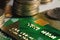 Close-up shallow depth of field credit card with microchip on the background of columns of metallic coins