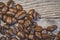 Close-up, shallow focus of dark roasted coffee beans seen ready to be ground up, to produce fresh coffee.