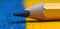 Close-up of a sharpened pencil on a vibrant background