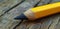 Close-up of a sharpened pencil on a wooden surface