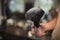 A close-up of a shaving accessory on a blurred background. A black brush in white talcum powder. Tools for cutting beard